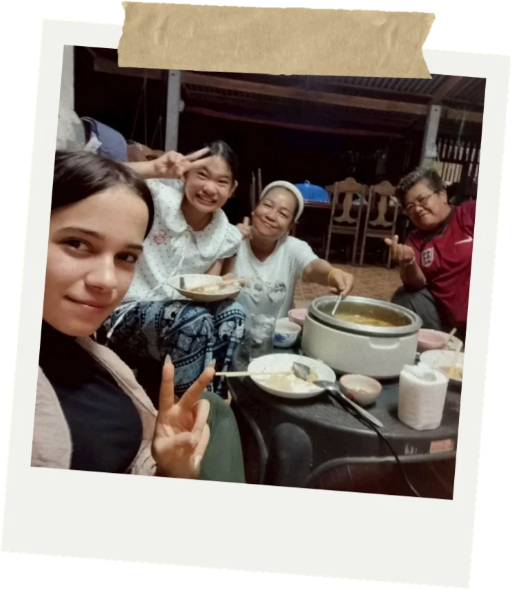 An AIESEC volunteer sharing a meal with her host family